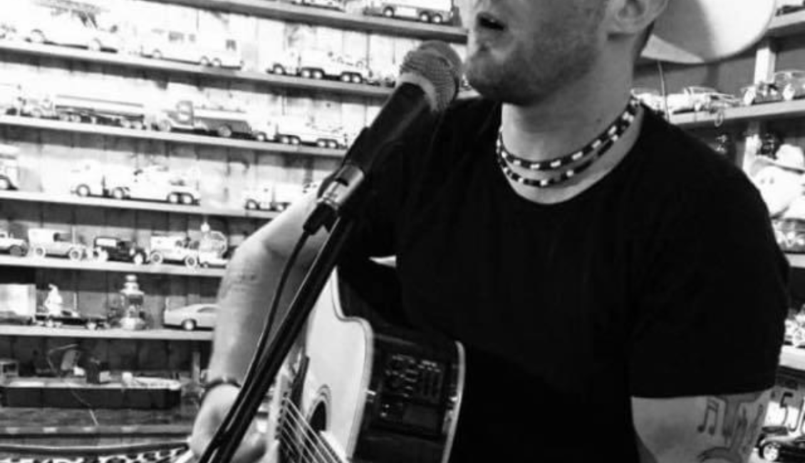 Black and white photograph of musican Brandon Scott
