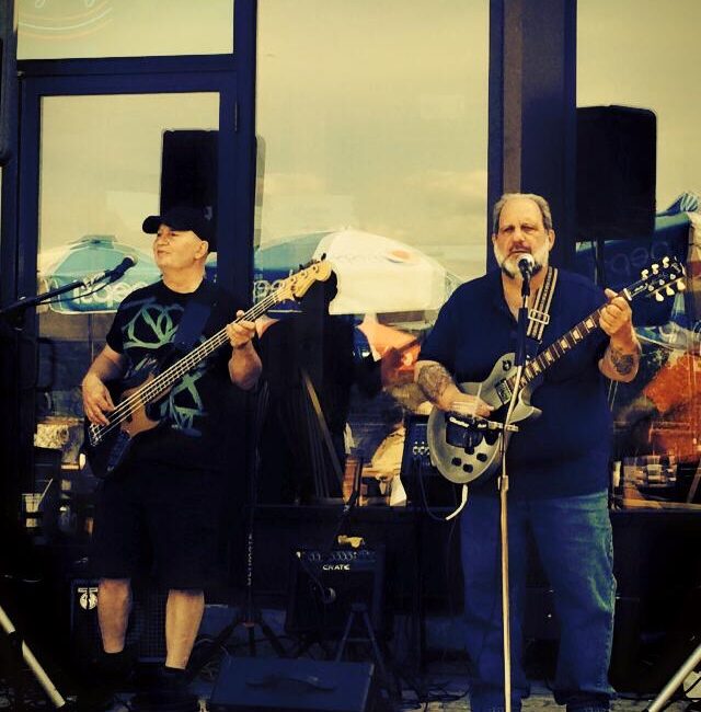 Color photograph of the Doc Orloff Duo standing on stage